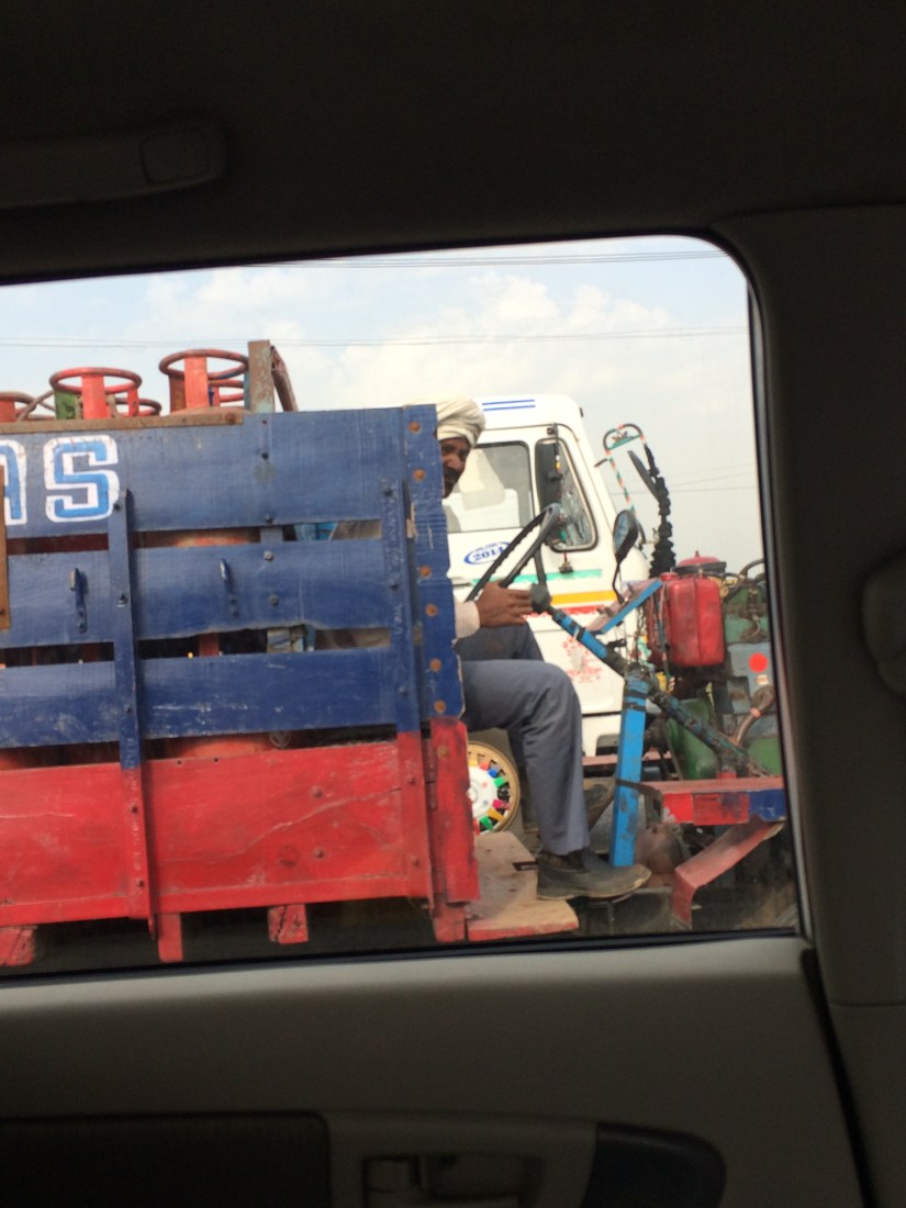 This is a tractor.  It was on the major highway leading out of Dehli.  It was kind of slow.